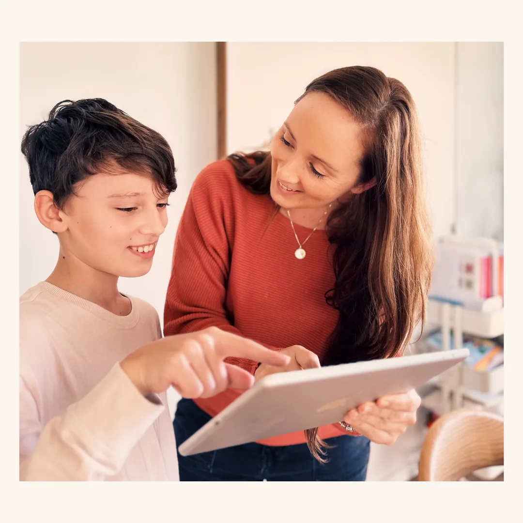 Tiffany Boyd and her son looking at an iPad together during their homeschool day.